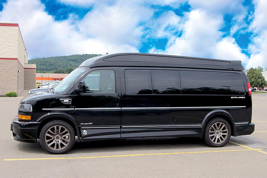 Black conversion van in parking lot