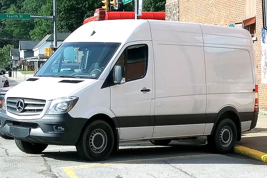 White Mercedes-Benz van backed into parking spot