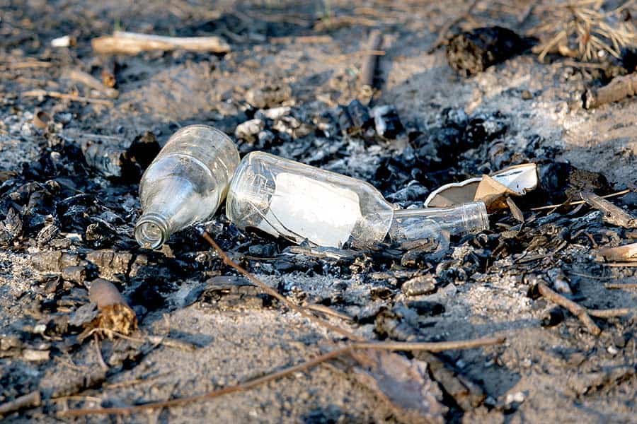 Bottles and debris in campfire pit