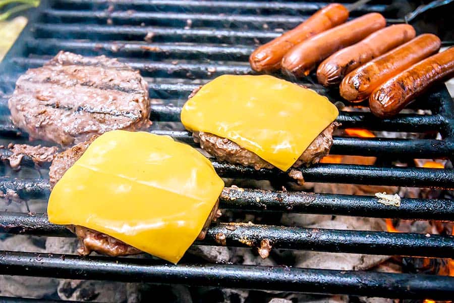 Cheeseburgers and hotdogs on camp grill