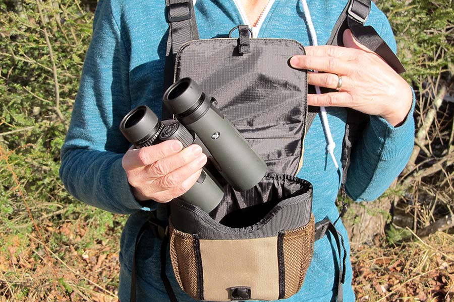 Woman taking binoculars out of carrying case