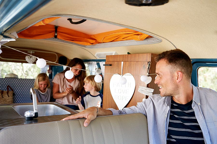 Family inside a pop top camper van