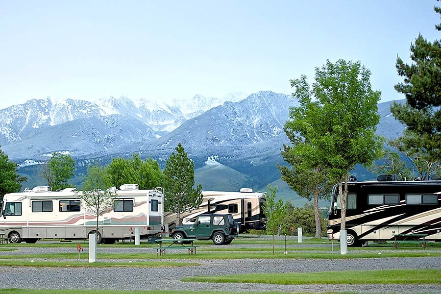 Motorhomes at RV park, snowcapped mountains in background