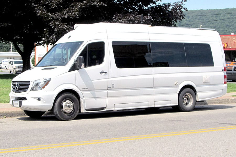 White Mercedes-Benz Sprinter van parked on street