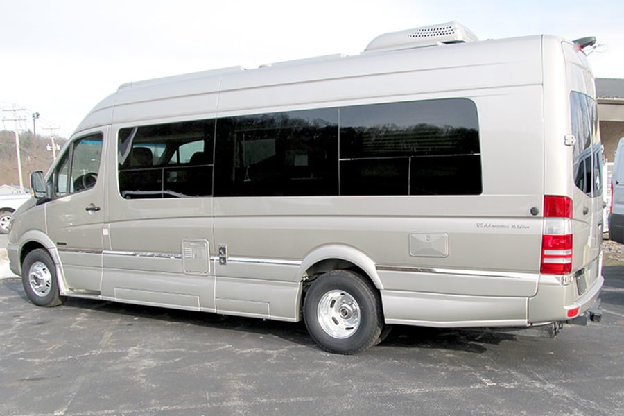 Light brown camper van in parking area