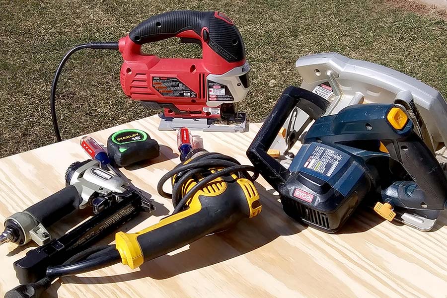 Assorted tools on a piece of plywood