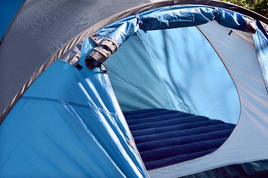 Blue tent with a blue air mattress inside