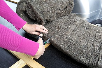 A woman cutting insulation