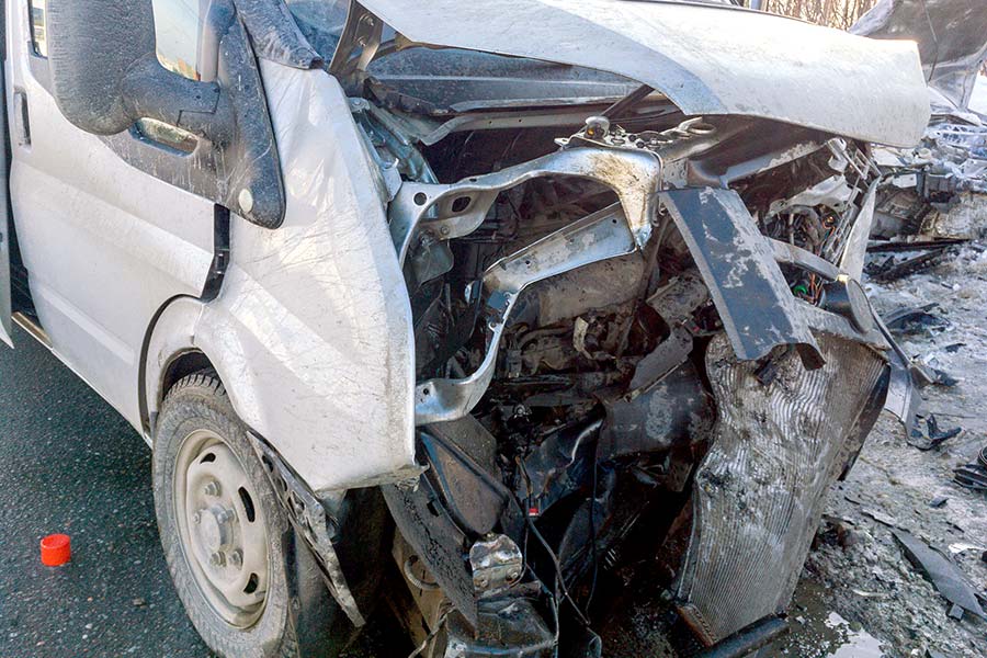 A gray van with the front end smashed