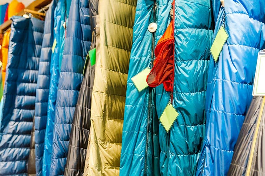 Different colored sleeping bags hanging up