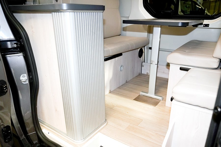 Table and seats inside of a camper van