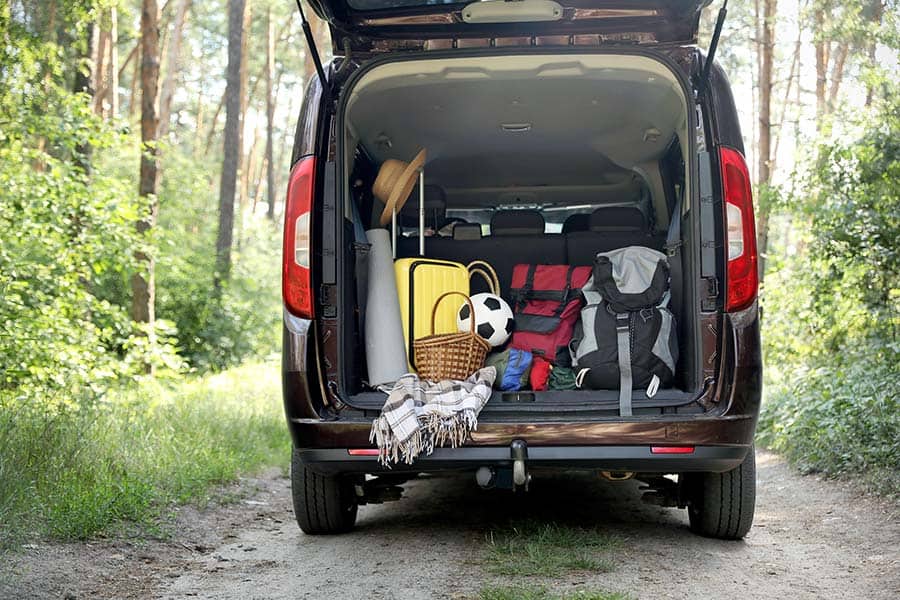 Van's rear hatch open showing camping gear