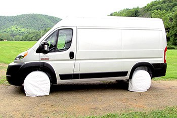Silver van with white tire covers