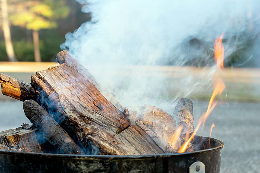 Wood burning and smoking in campfire ring