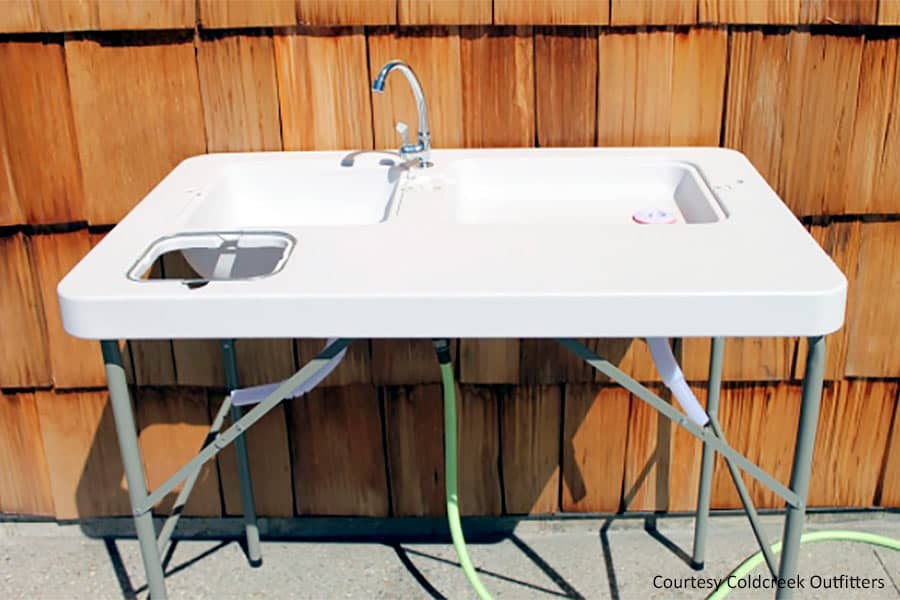 Portable sink beside wood shingle wall