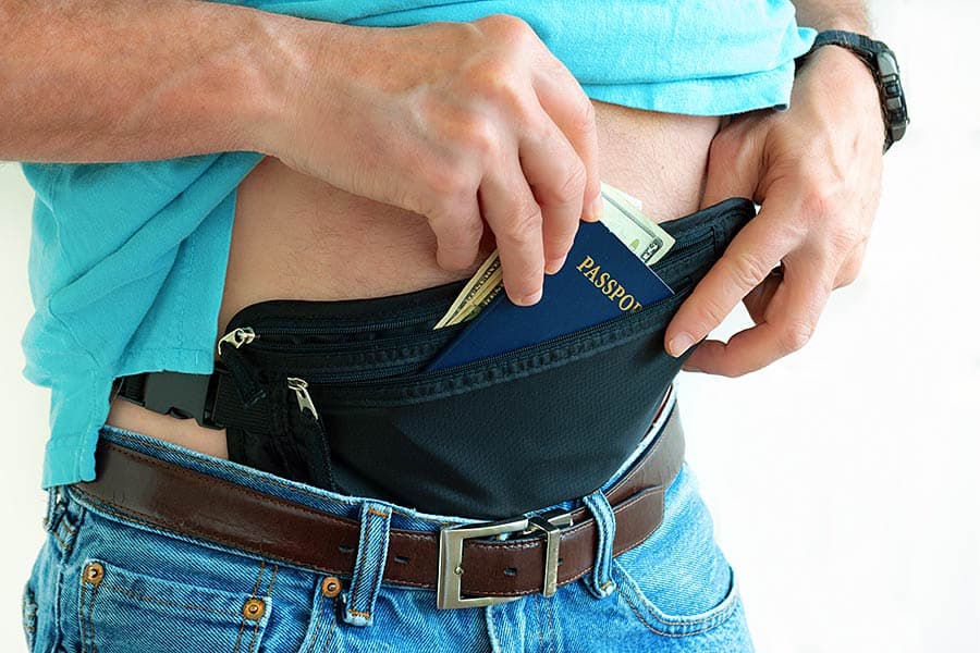 Man placing valuables in hidden money belt