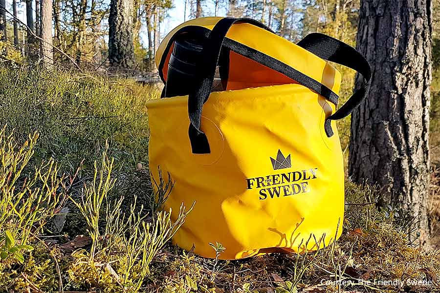 Yellow Friendly Swede bag sitting on ground by tree