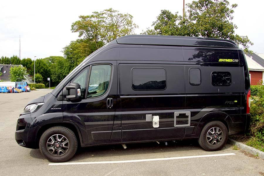 Dark blue Hymer camper van backed into parking spot