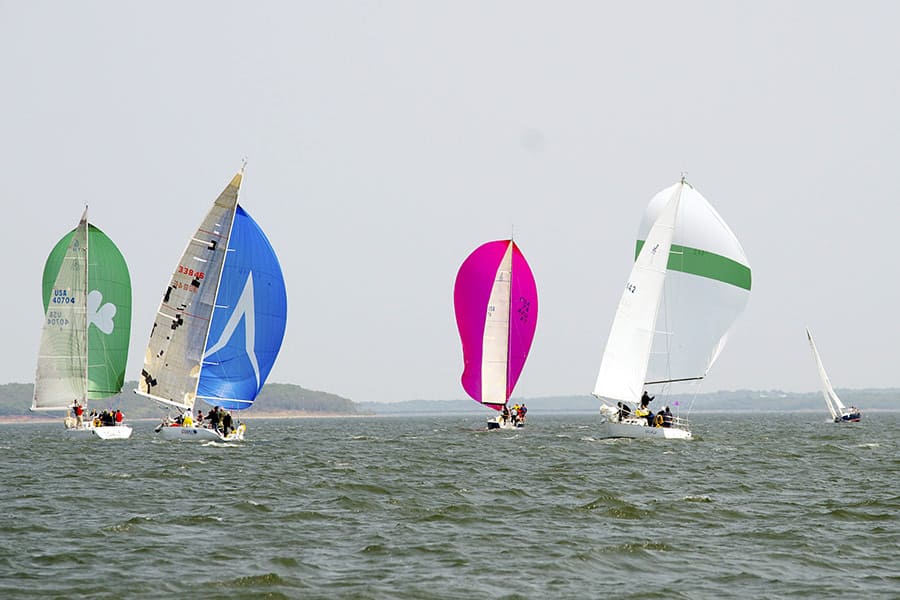 Group of multi-colored sailboats on Lake Texoma reservoir