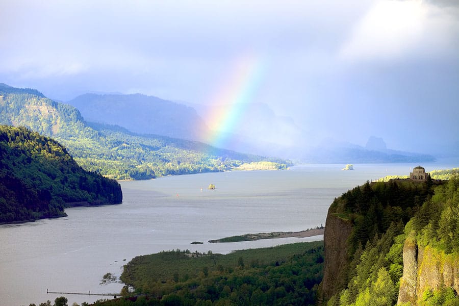 Rugged cliffs on the Columbia River Gorge, with rainbow