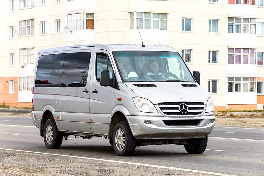 Gray van on street in urban area