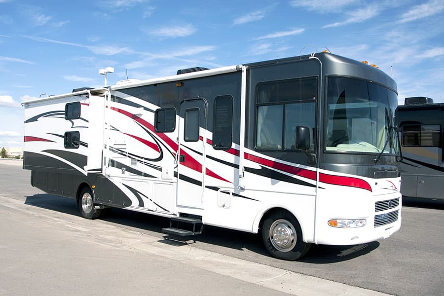 White and black motorhome parked on blacktop