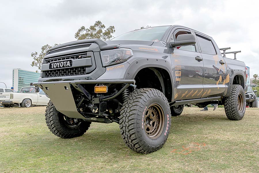 Dark colored Toyota Tundra parked on grass