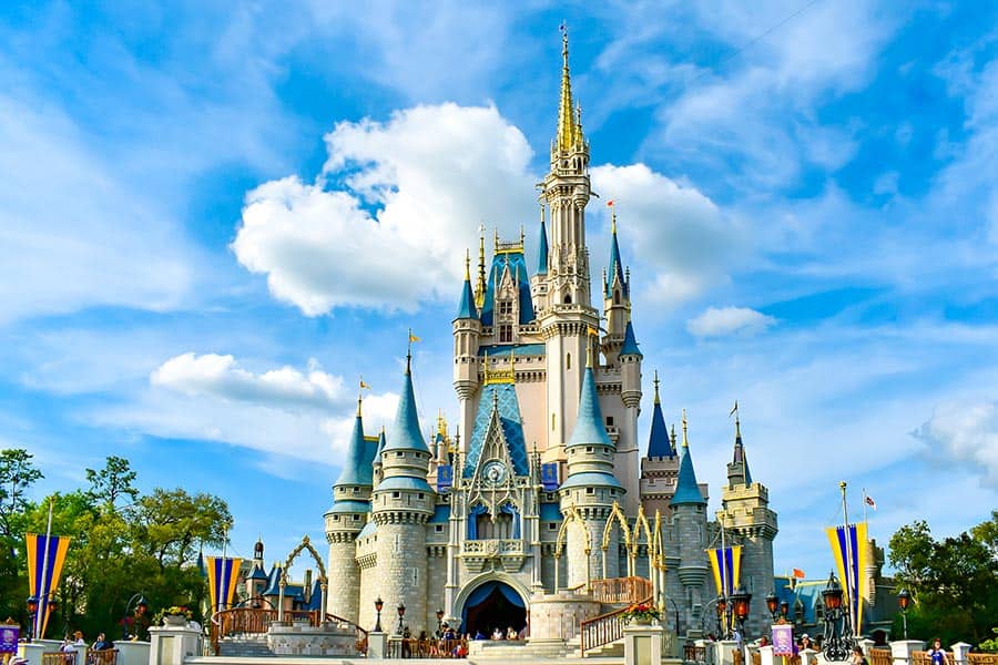 Disney castle with blue sky and puffy white clouds
