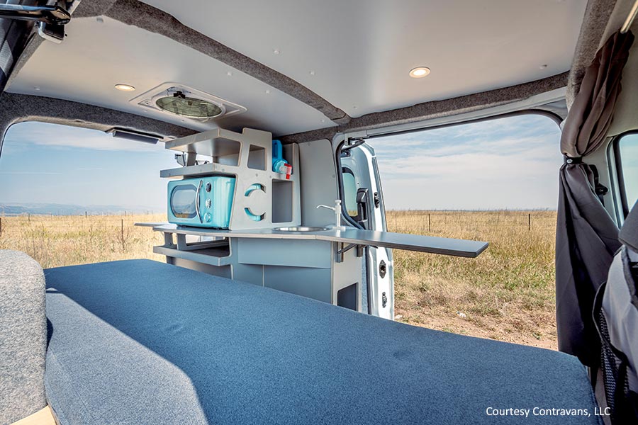 Interior view of conversion van's bed and kitchen area