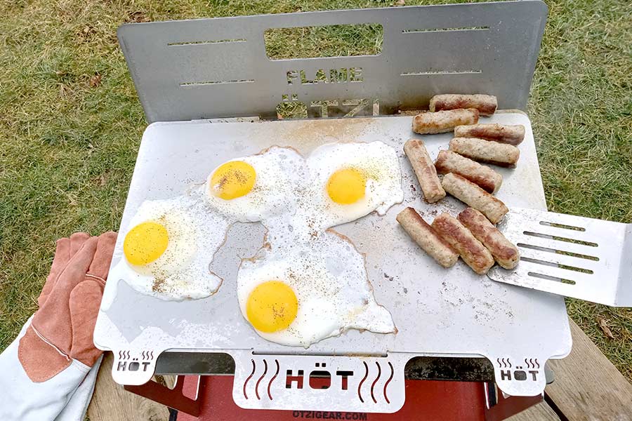 Eggs and sausage on grill