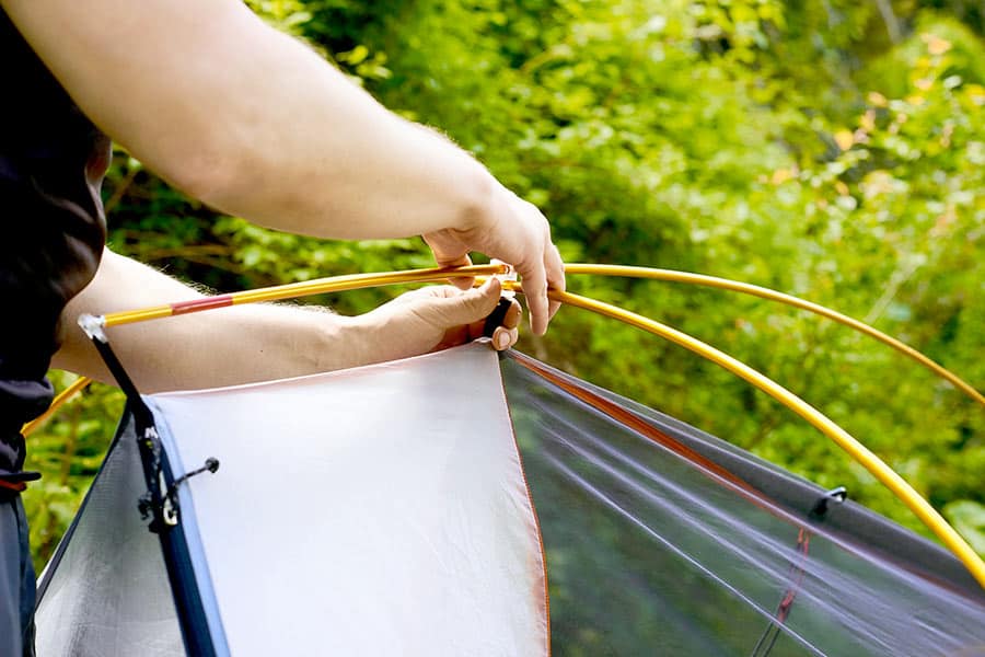 Man assembling tent poles