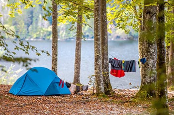 Tent with clothes on line between trees