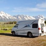 Camper van with snow capped mountains in background