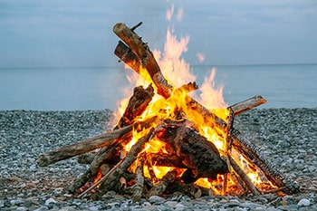 Campfire on rocky shore