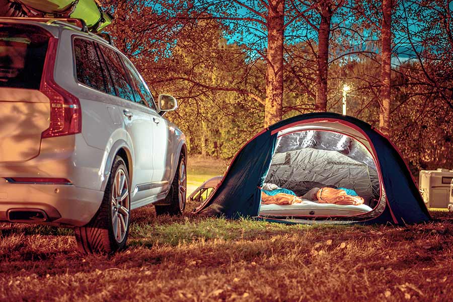 Couple traveling by car and camping in a Tent