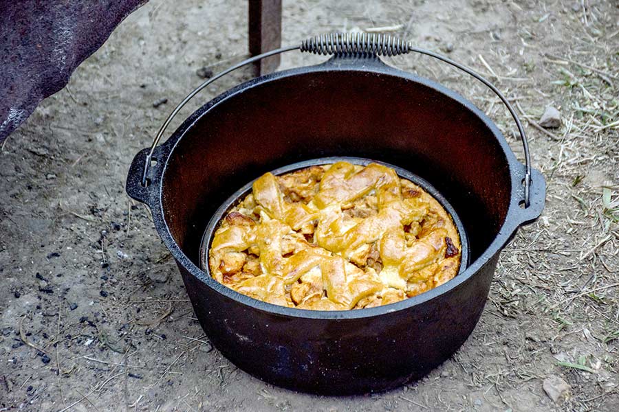 Apple pie cooked in Dutch over campfire