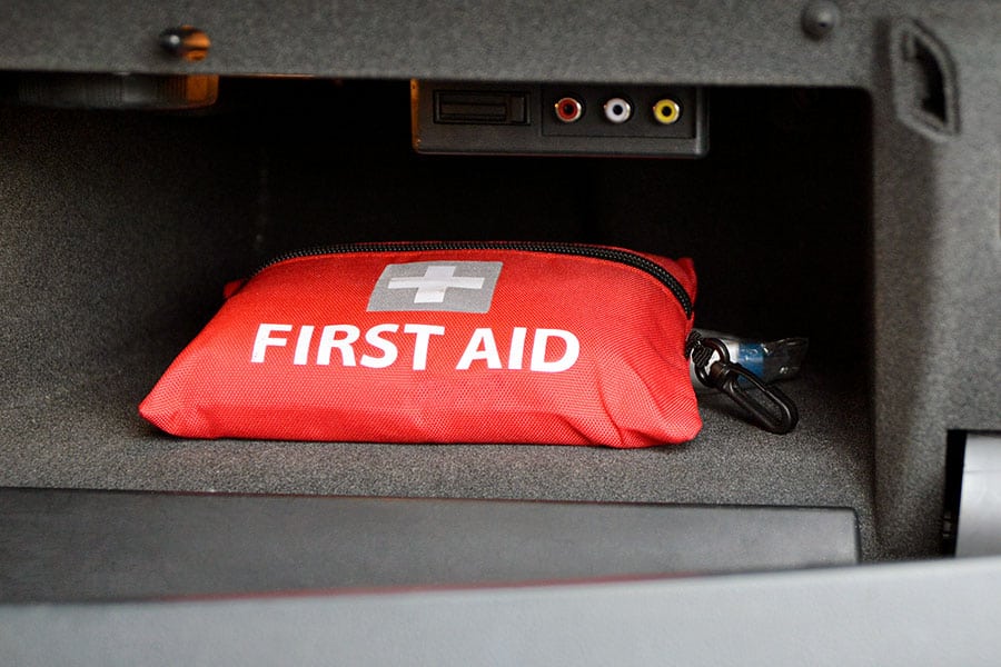 Red first aid kit in glove compartment