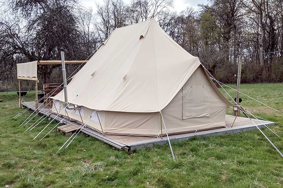 Large glamping tent pitched in meadow