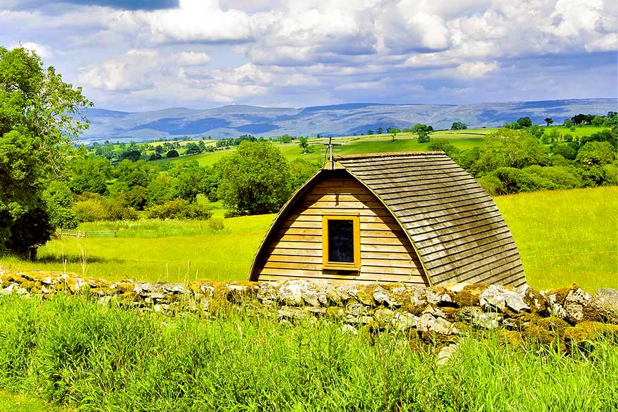 Wooden yurt in a secluded area overlooking valley