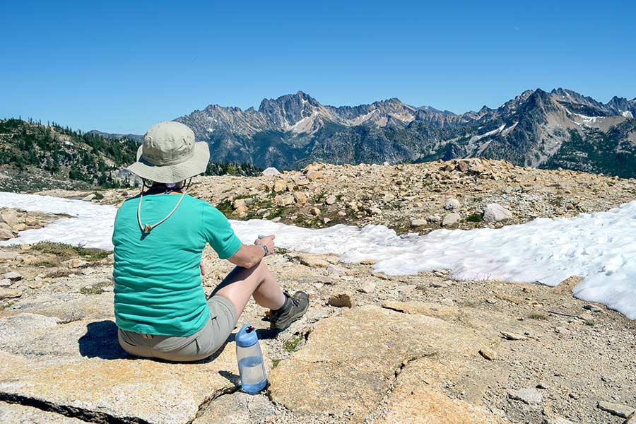 Man resting after hiking to top of mountain