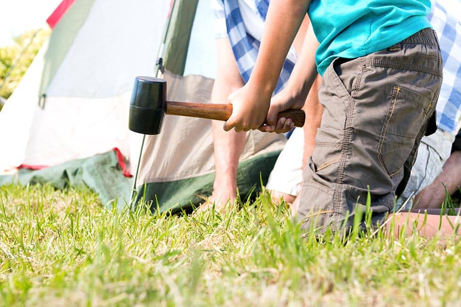 Father and son pitching a tent