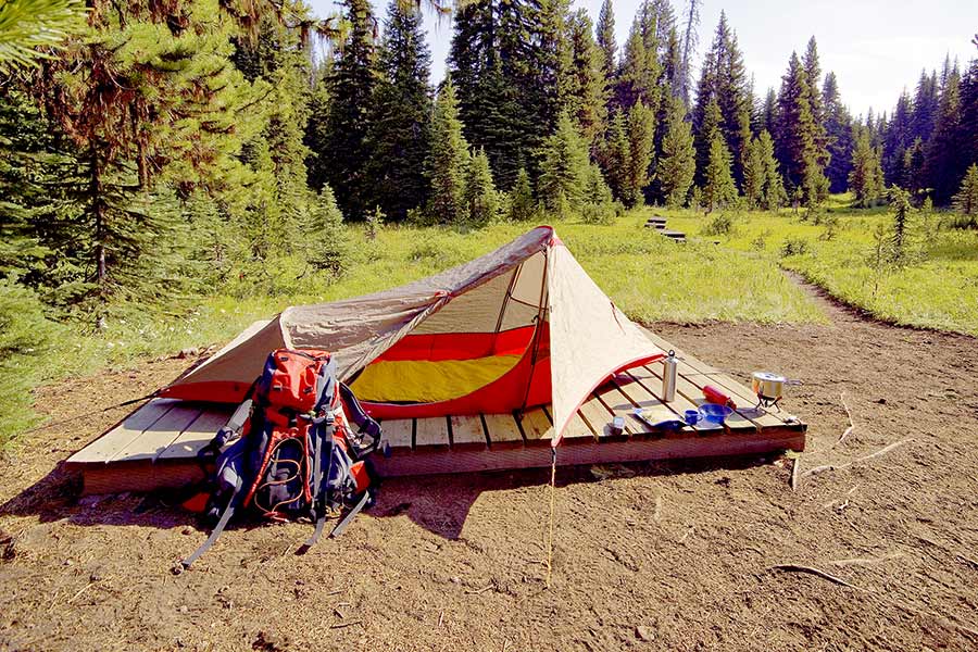 Tent pitched on wooden platform in the wilderness