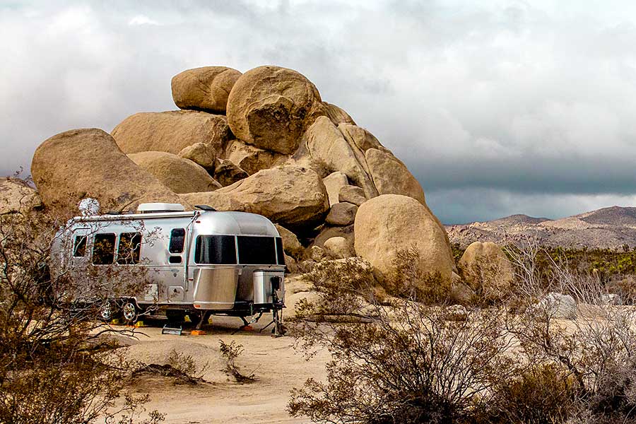 Airstream camper trailer parked in desert campground