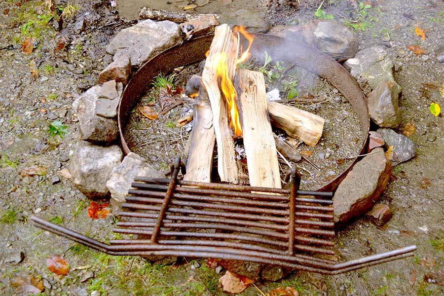 Starting campfire in fire ring at campground