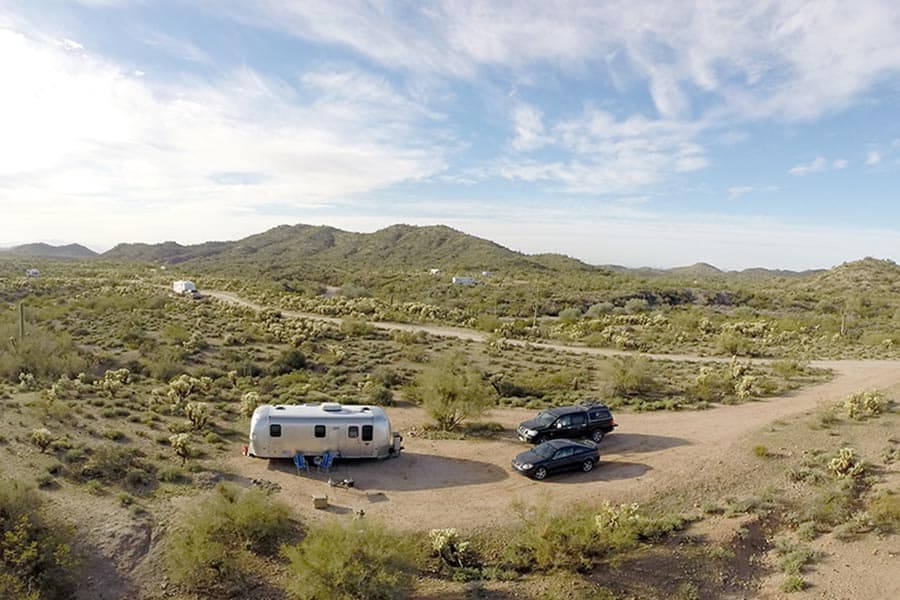 Airstream camping trailer parked in a remote desert location
