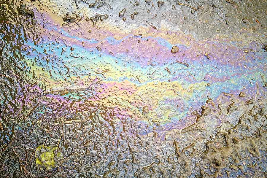 Gasoline spilled on ground has rainbow colors
