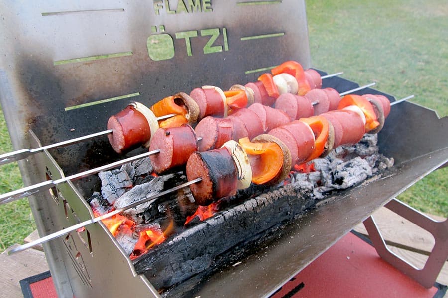 kebabs cooking on portable fire pit