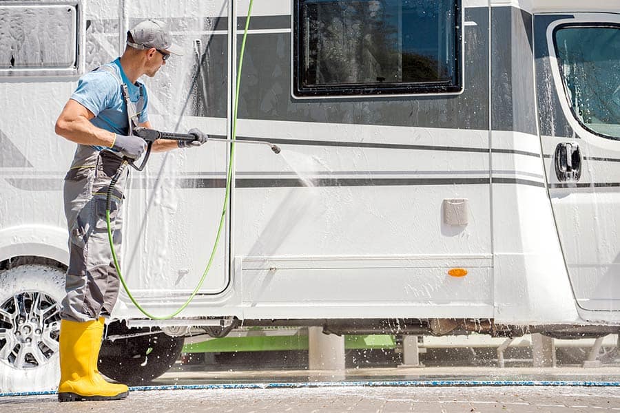 Man power washing his motorhome