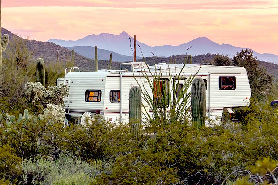 Camper trailer park among desert cactus and brush