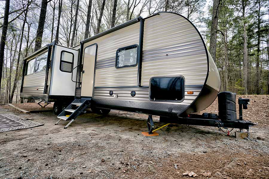 Travel trailer parked in the forest